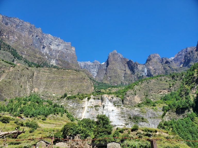 Mountain landscape with waterfalls and cliffs on the Manaslu Circuit Trek route in Nepal.