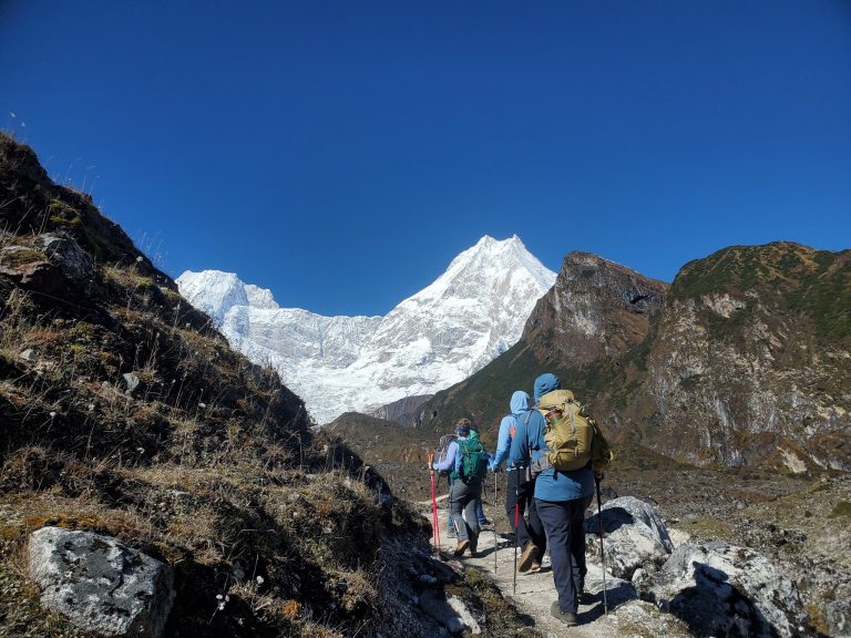Trekkers on the Short Manaslu Circuit Trek trail with mountain views.